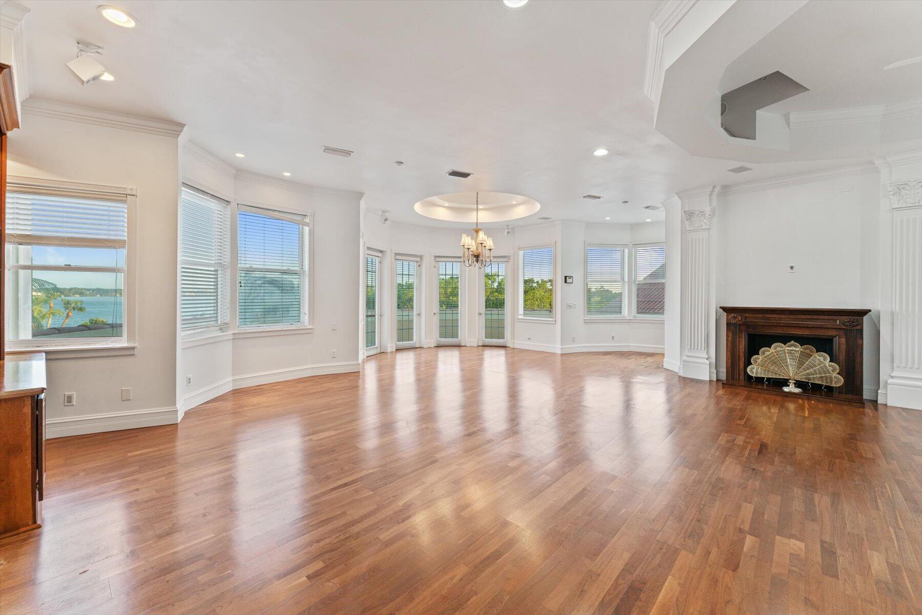 49 West High Point Road Sewall's Point, FL 34996 - Photo 56 of 99 a view of an empty room with wooden floor and a fireplace