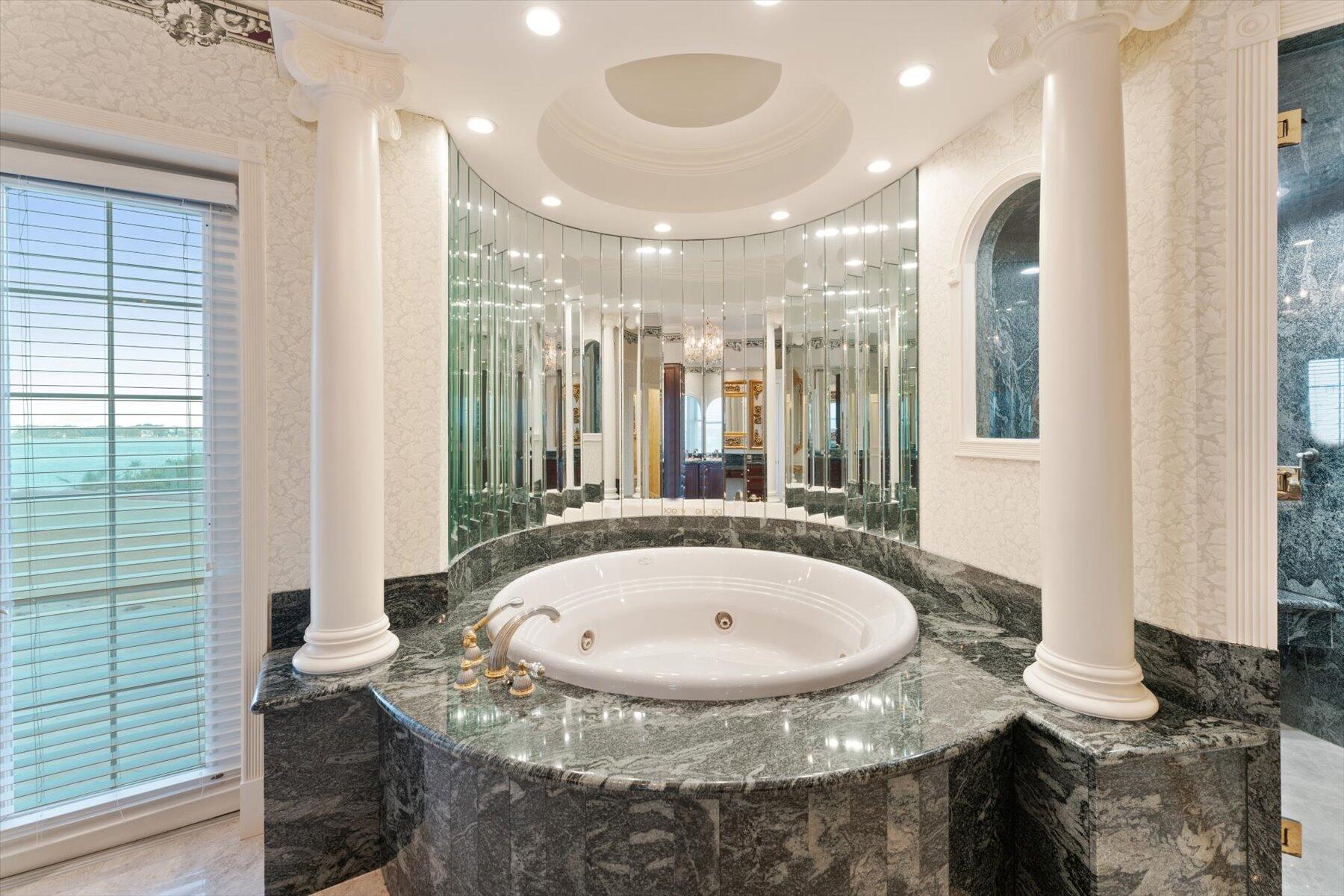 49 West High Point Road Sewall's Point, FL 34996 - Photo 63 of 99 a bathroom with a sink and a mirror