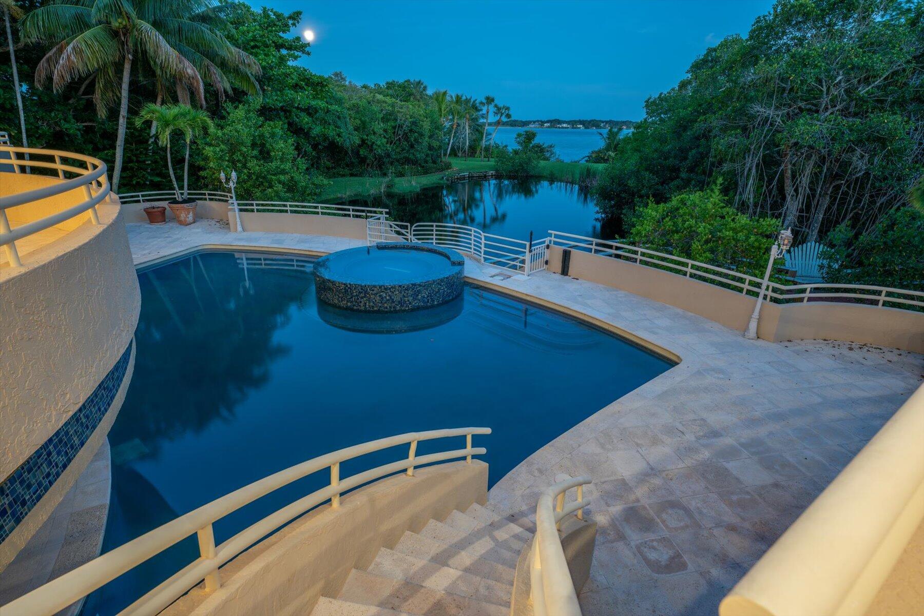 49 West High Point Road Sewall's Point, FL 34996 - Photo 69 of 99 a view of a swimming pool with a patio