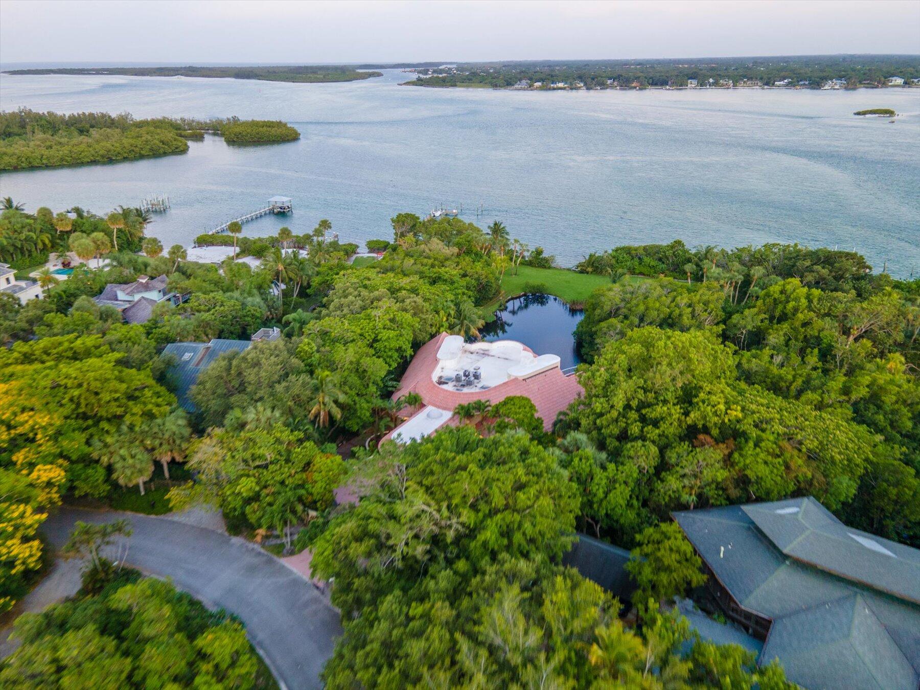 49 West High Point Road Sewall's Point, FL 34996 - Photo 7 of 99 a view of a lake with a building in the background