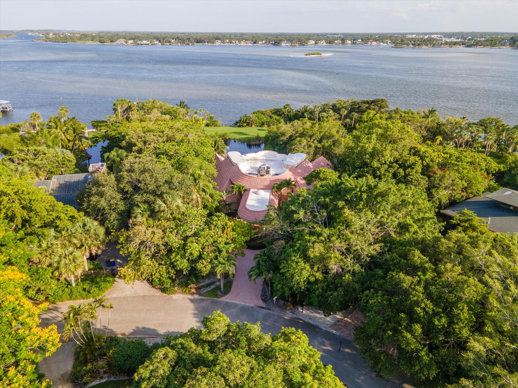 49 West High Point Road Sewall's Point, FL 34996 - Photo 72 of 99 a view of a lake with a building in the background