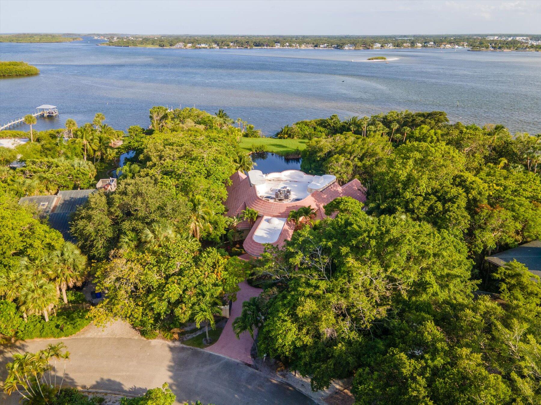 49 West High Point Road Sewall's Point, FL 34996 - Photo 74 of 99 a view of a lake with a building in the background