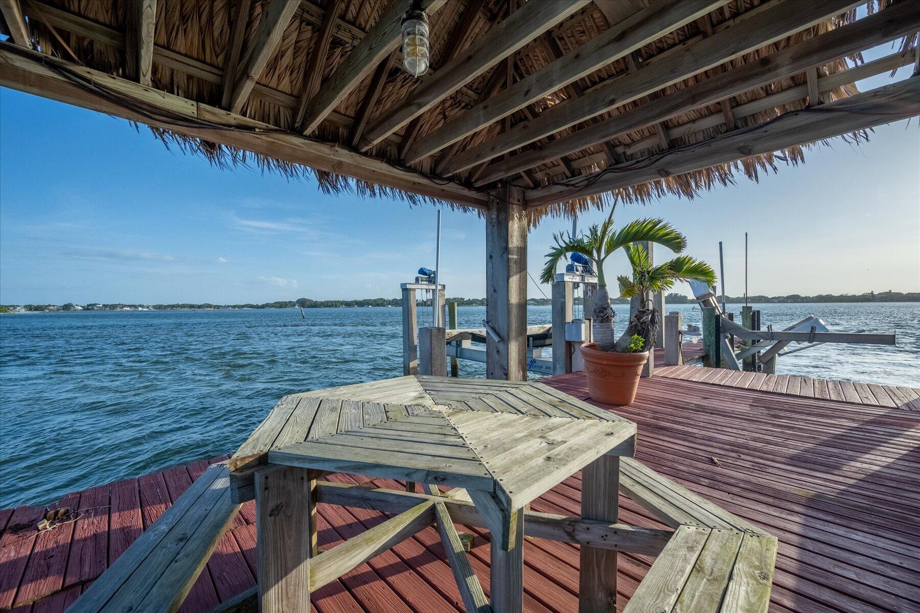 49 West High Point Road Sewall's Point, FL 34996 - Photo 82 of 99 a view of a balcony with table and chairs