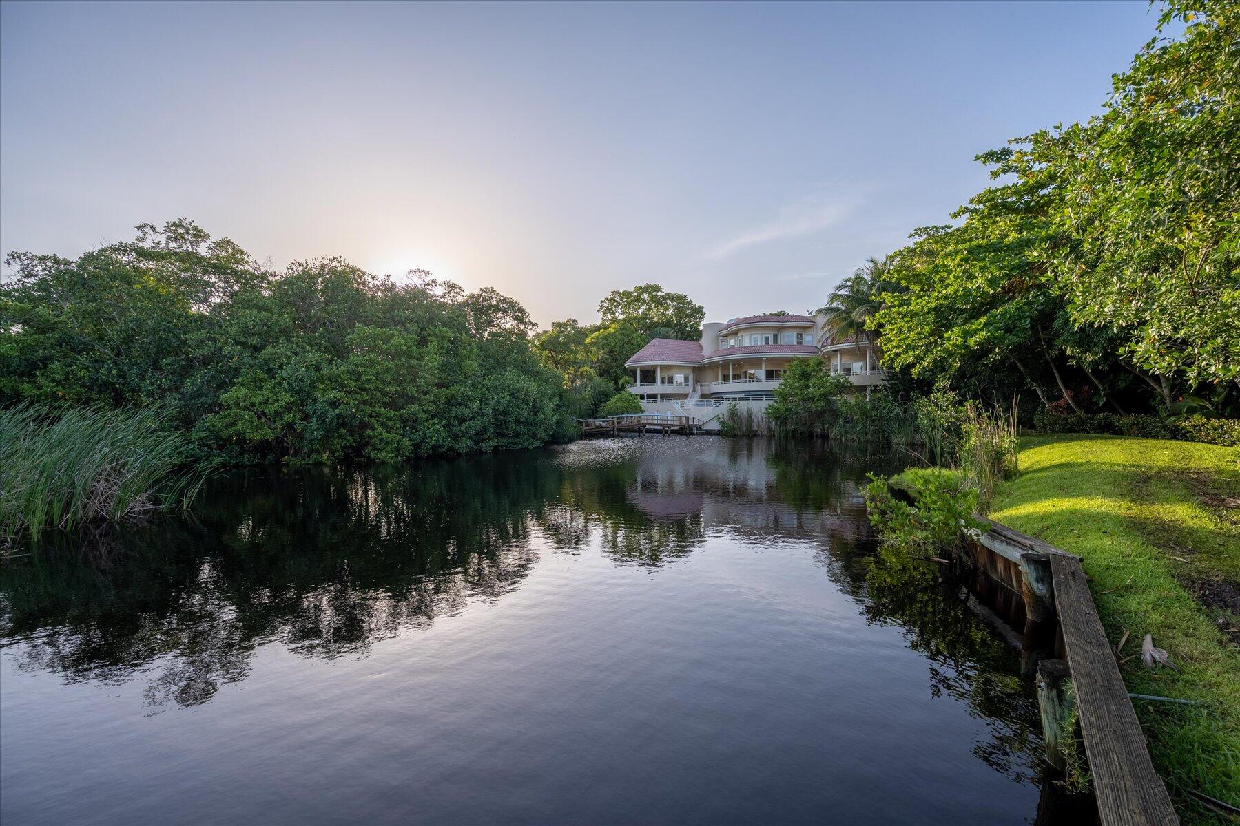 49 West High Point Road Sewall's Point, FL 34996 - Photo 91 of 99 a view of a lake with a building in front of it