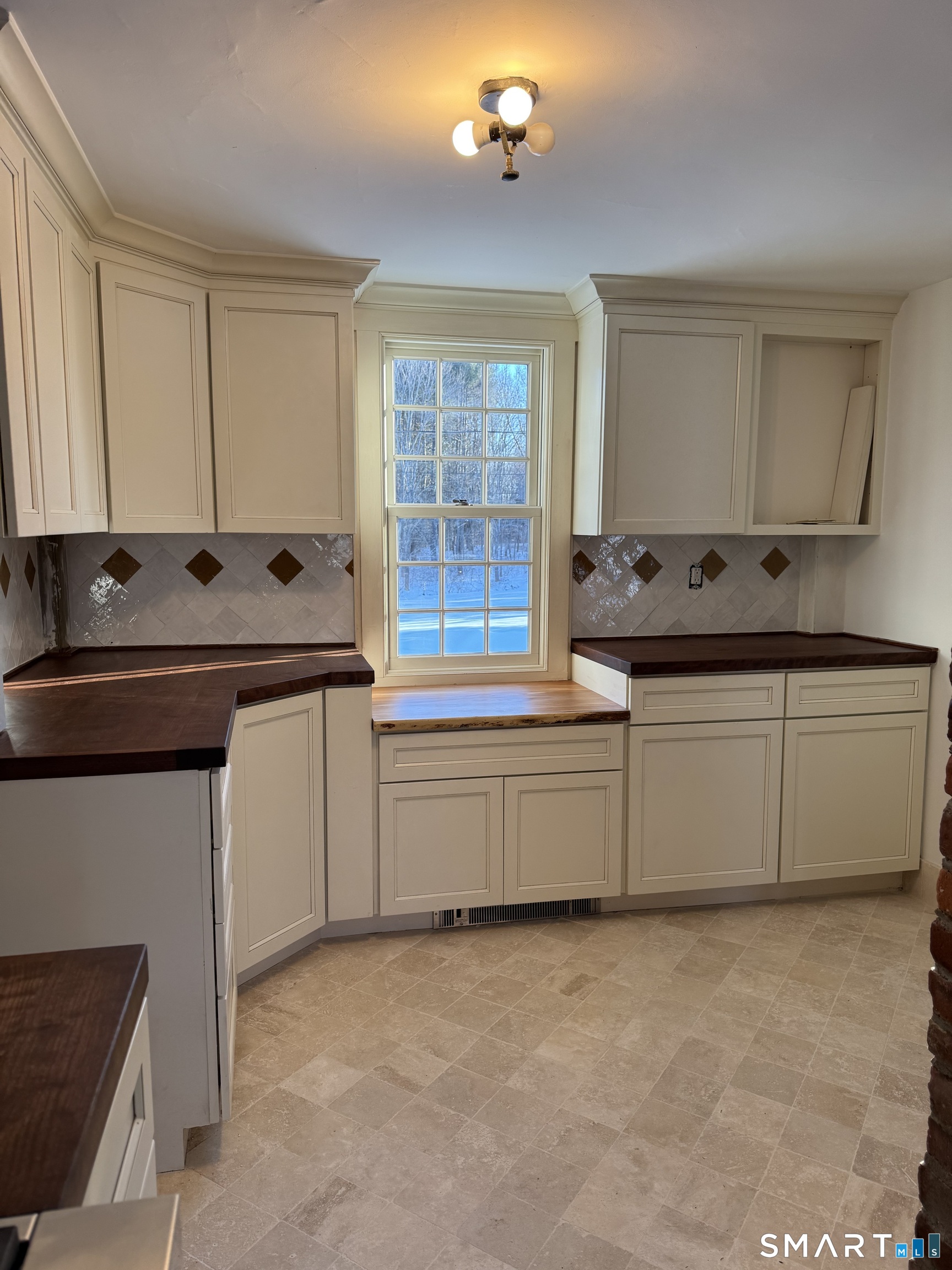 30 Hopyard Road East Haddam, CT 06423 - Photo 25 of 42 a kitchen with granite countertop a sink and white cabinets