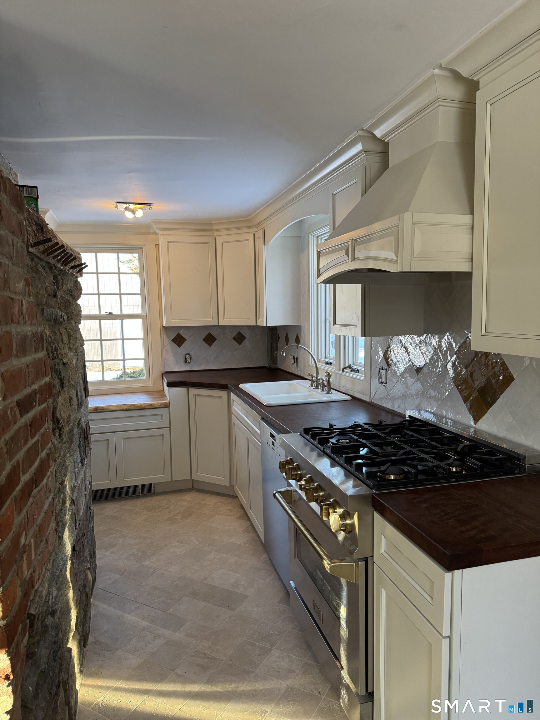30 Hopyard Road East Haddam, CT 06423 - Photo 27 of 42 a kitchen with granite countertop a stove and a sink