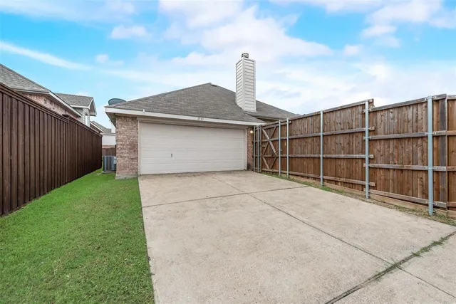 a view of a backyard with wooden fence