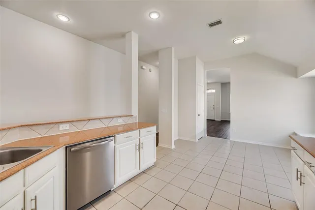 a view of a kitchen with white cabinets