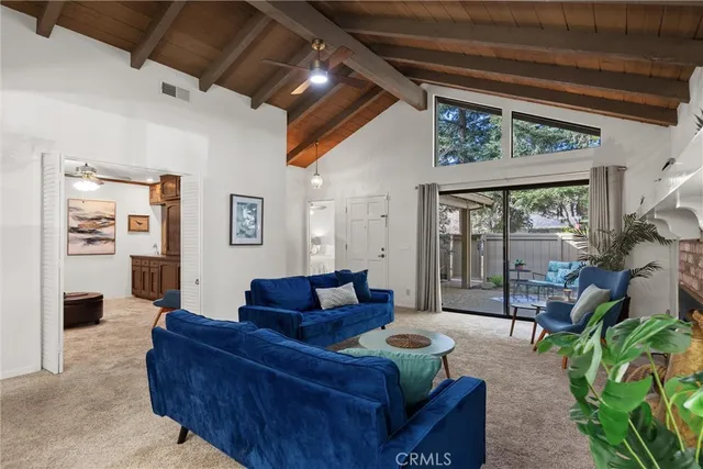 a bedroom with a bed mirror on dresser and a chandelier