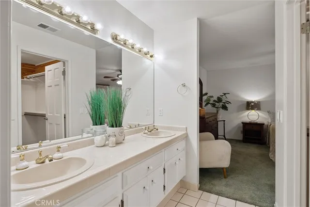 a bathroom with a double vanity sink and a mirror