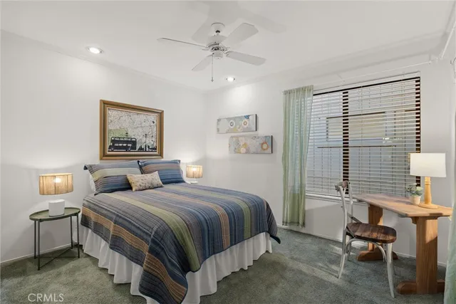 a bedroom with a bed and a workspace