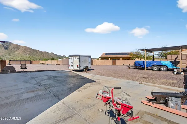 a large kitchen with stainless steel appliances granite countertop a refrigerator a sink dishwasher a stove and white countertops with wooden floor