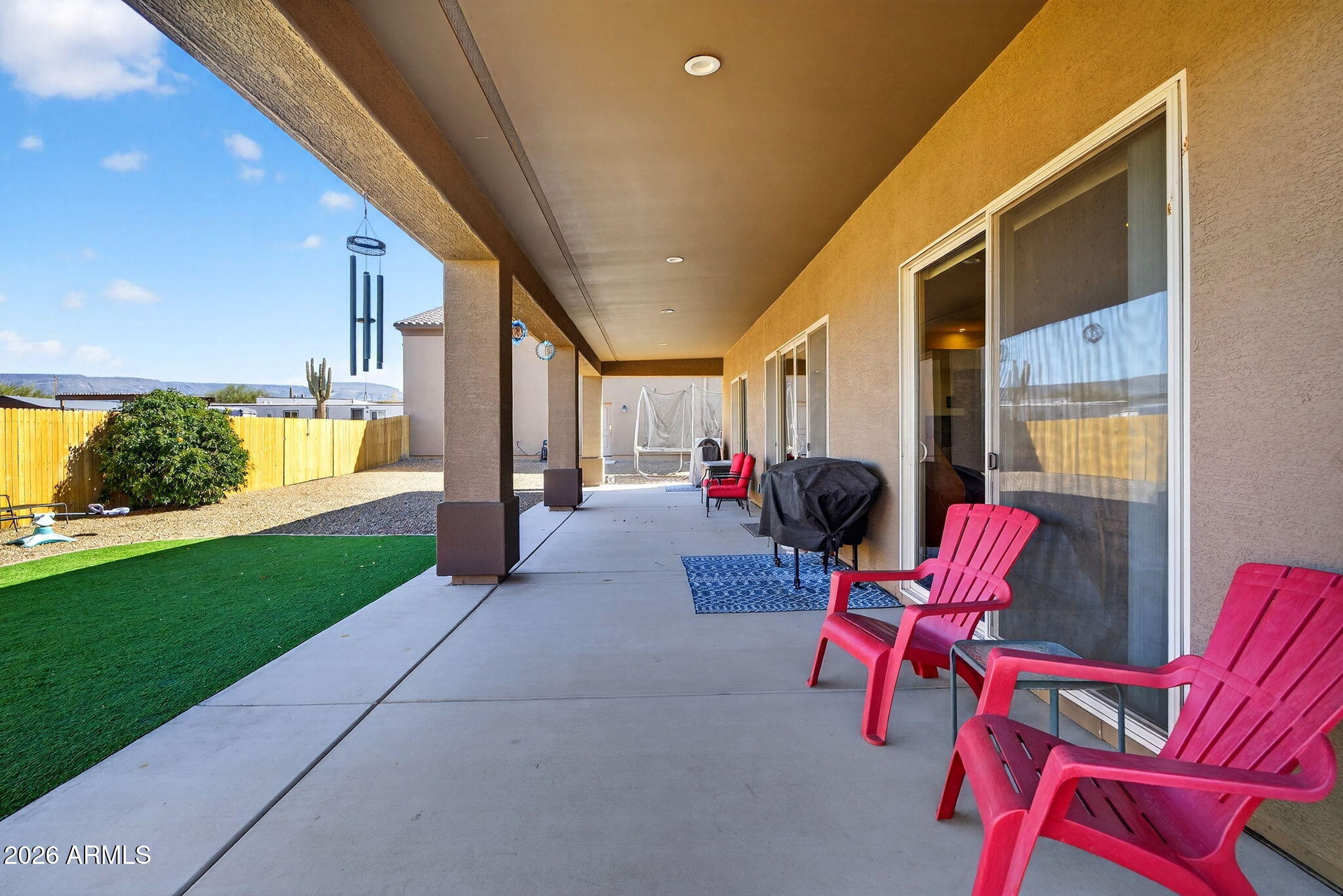 112 West Circle Mountain Road New River, AZ 85087 - Photo 16 of 57 a living room with patio furniture and a potted plant