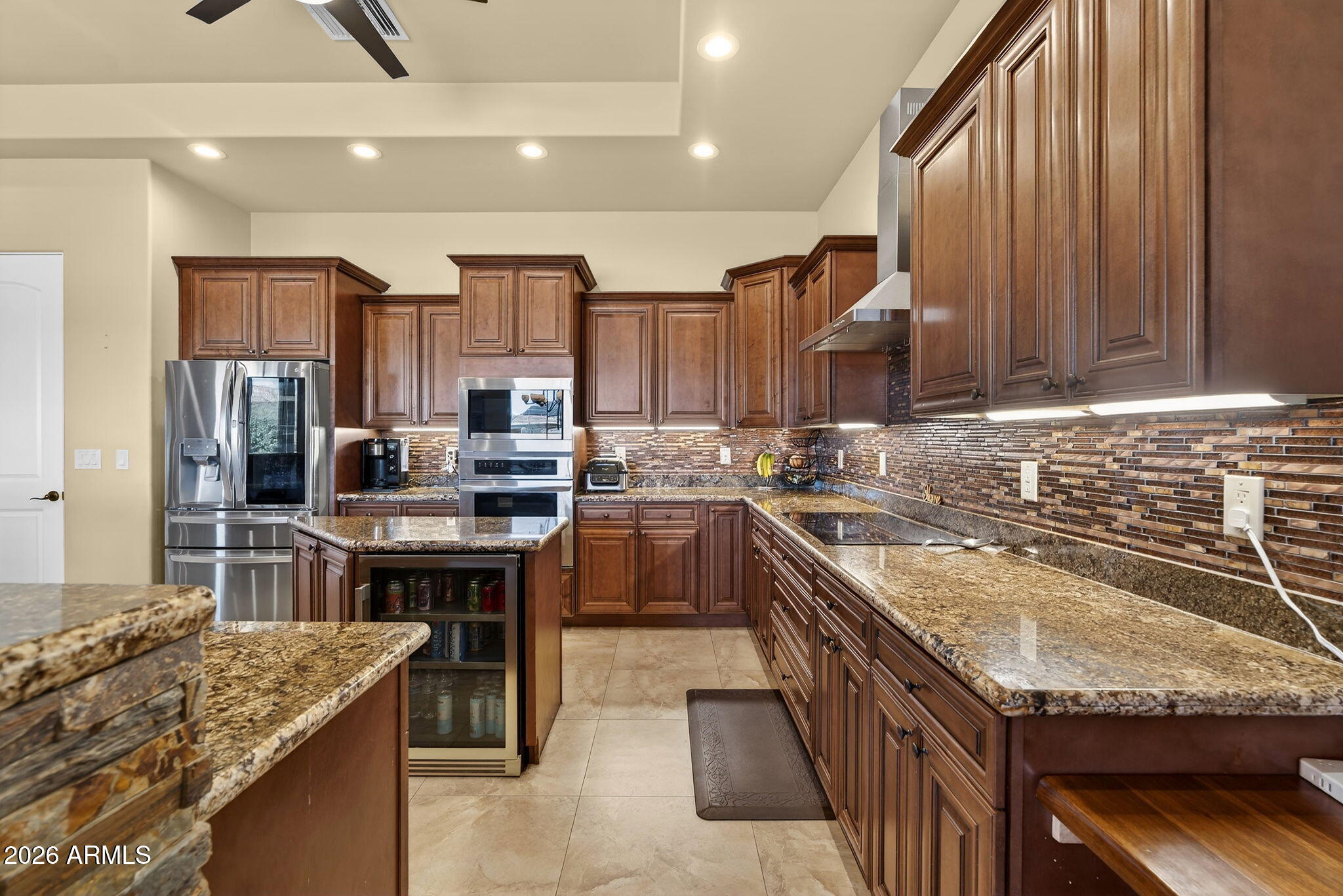 112 West Circle Mountain Road New River, AZ 85087 - Photo 23 of 57 a kitchen with granite countertop kitchen island stainless steel appliances a sink stove and refrigerator