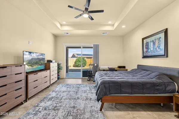a living room with patio furniture and a floor to ceiling window
