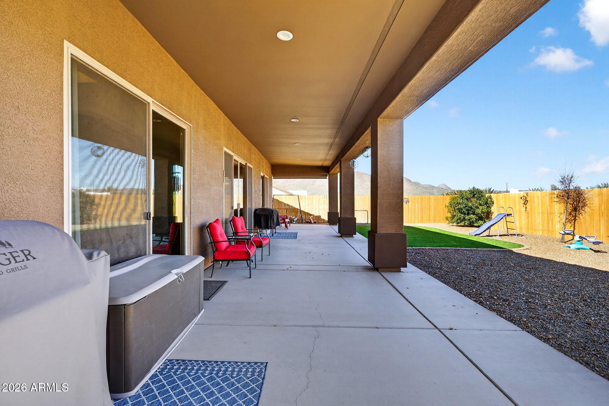112 West Circle Mountain Road New River, AZ 85087 - Photo 45 of 57 a living room with patio furniture and a floor to ceiling window