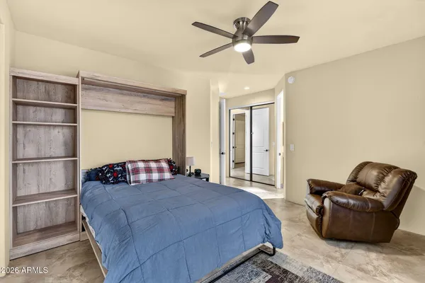 a bedroom with a bed couch and a window