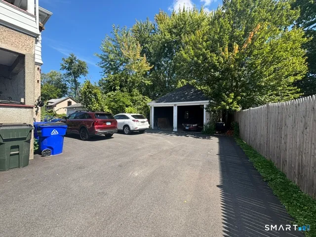 a car parked in front of house with trees