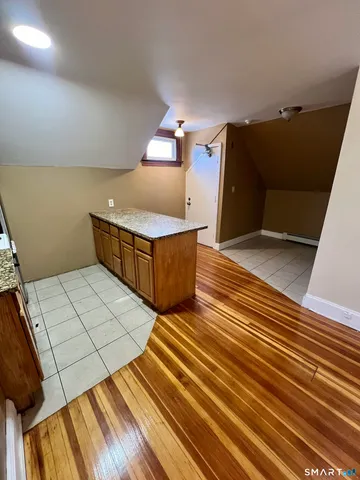 a view of a room with wooden floor