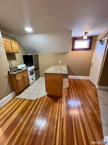 a bed sitting in a room next to a lamp