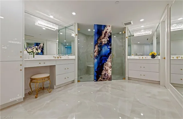 a bedroom with a bed table flowerpot and a large mirror