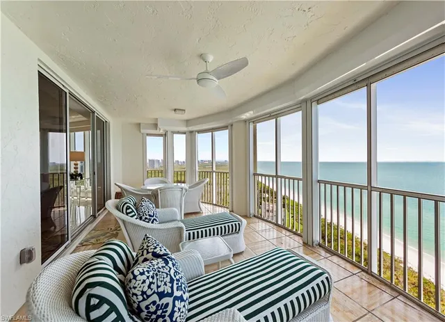 a view of a balcony with a floor to ceiling window next to a yard