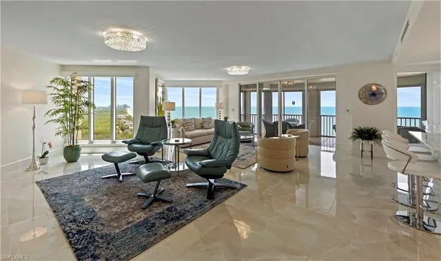 a living room with furniture large window and a table