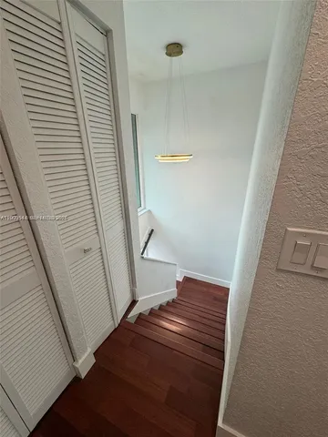 a view of a room with wooden floor and doors