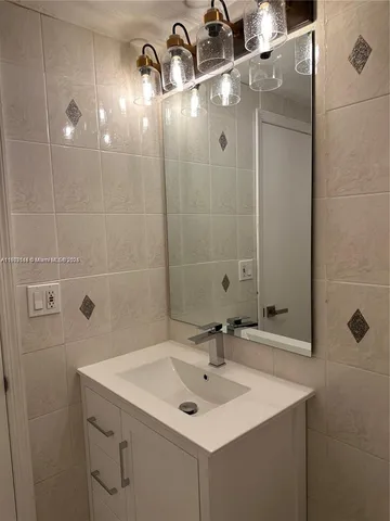 a view of a kitchen with a sink and dishwasher a refrigerator a fireplace