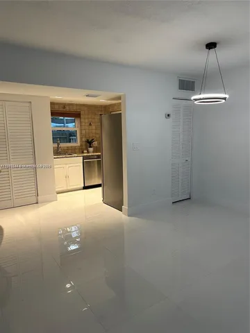 a view of a kitchen with a sink a fireplace and cabinets