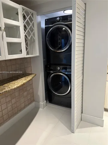 an empty room with chandelier fan