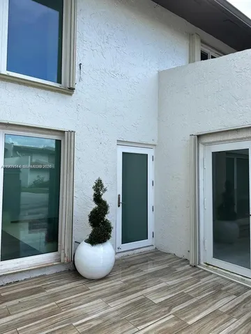 a view of a potted plant in front of a room