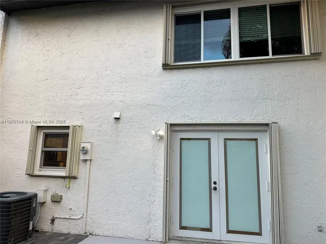a front view of a house with outdoor seating