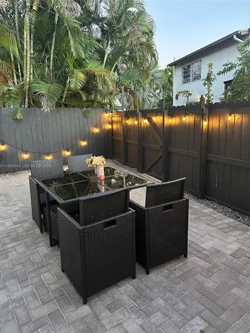 a front view of a house with outdoor seating