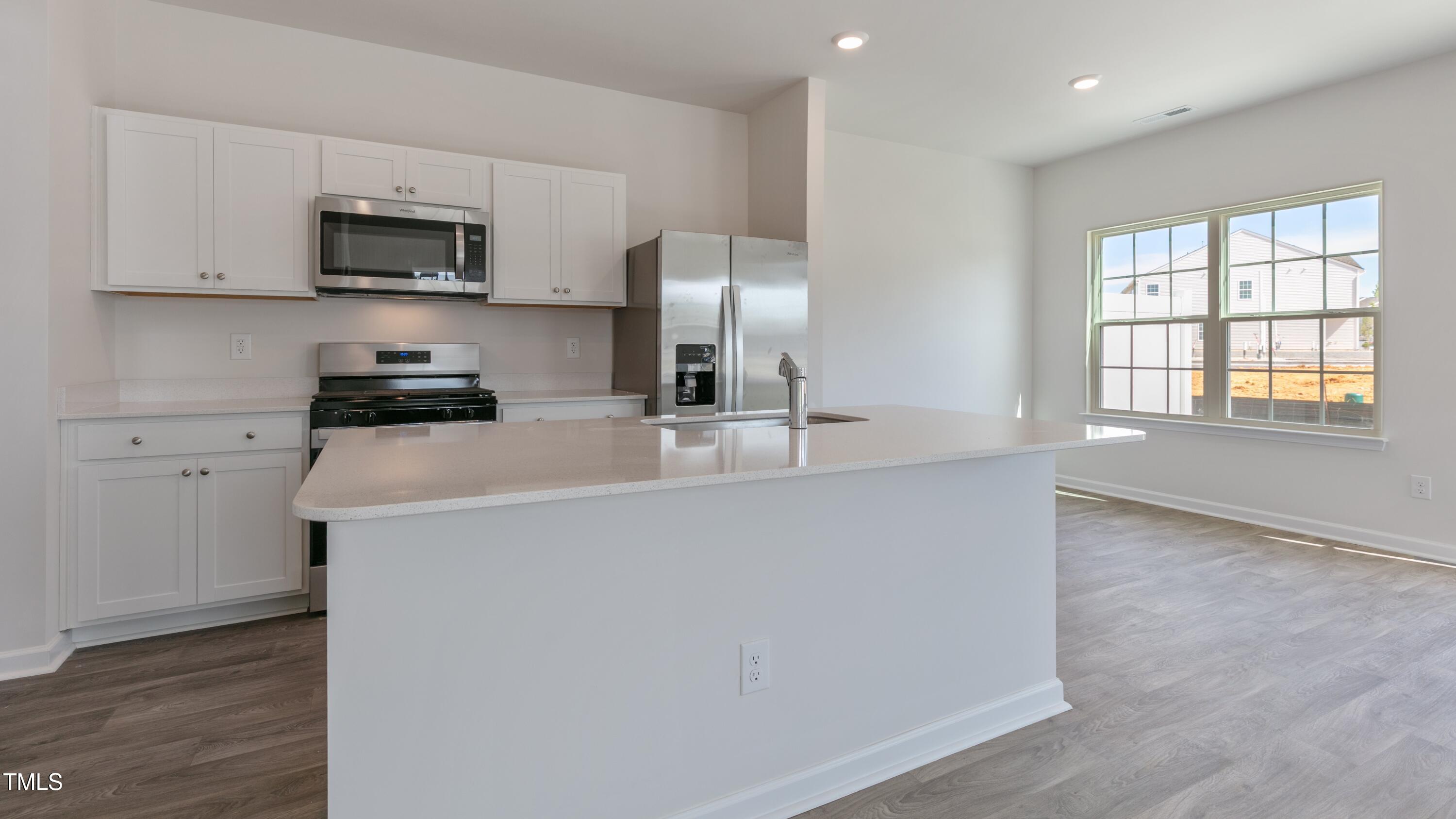 39 Virgo Drive Angier, NC 27501 - Photo 7 of 31 a kitchen with stainless steel appliances a microwave a sink and a refrigerator