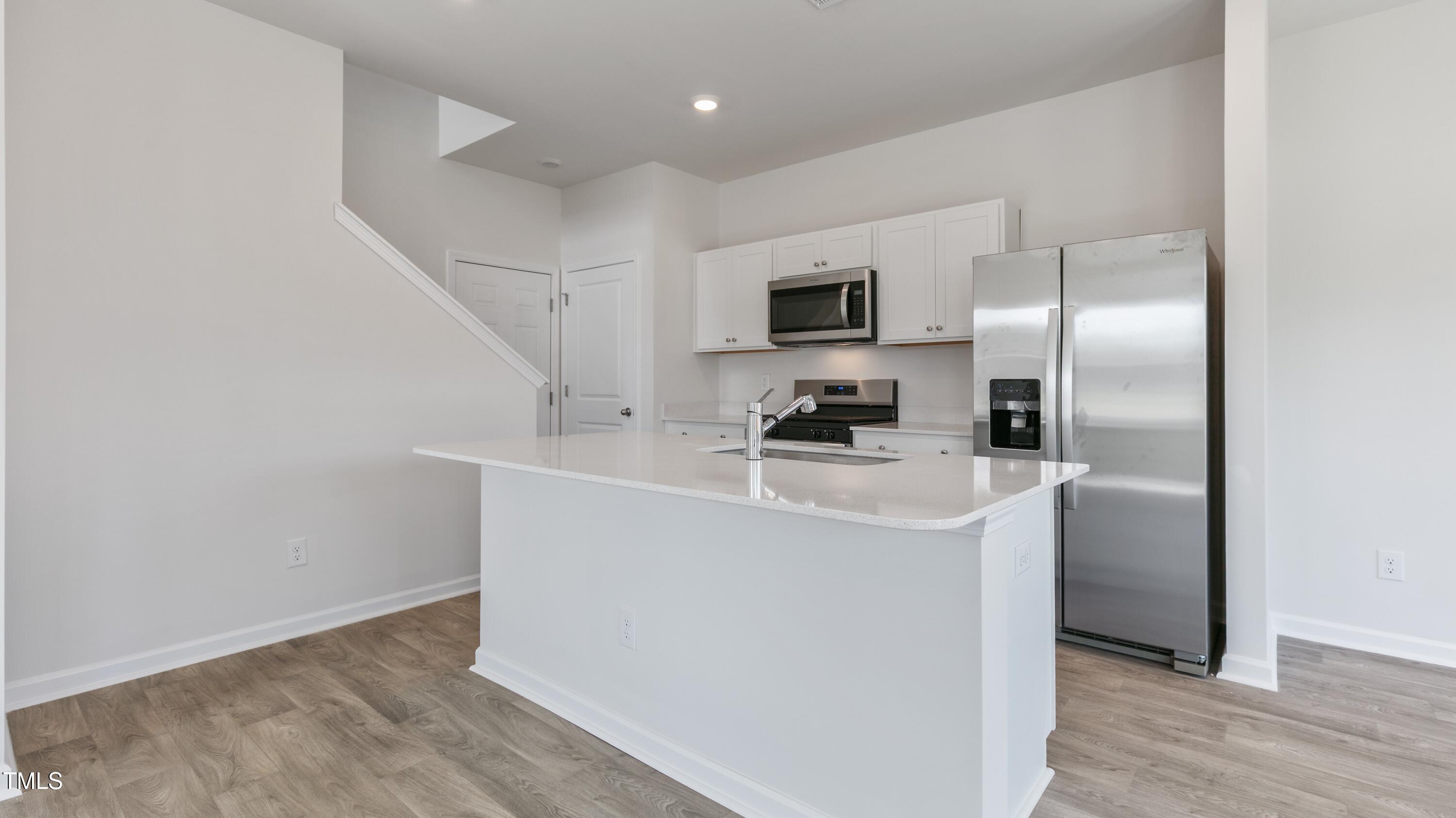 39 Virgo Drive Angier, NC 27501 - Photo 8 of 31 a kitchen with kitchen island a sink stainless steel appliances and refrigerator