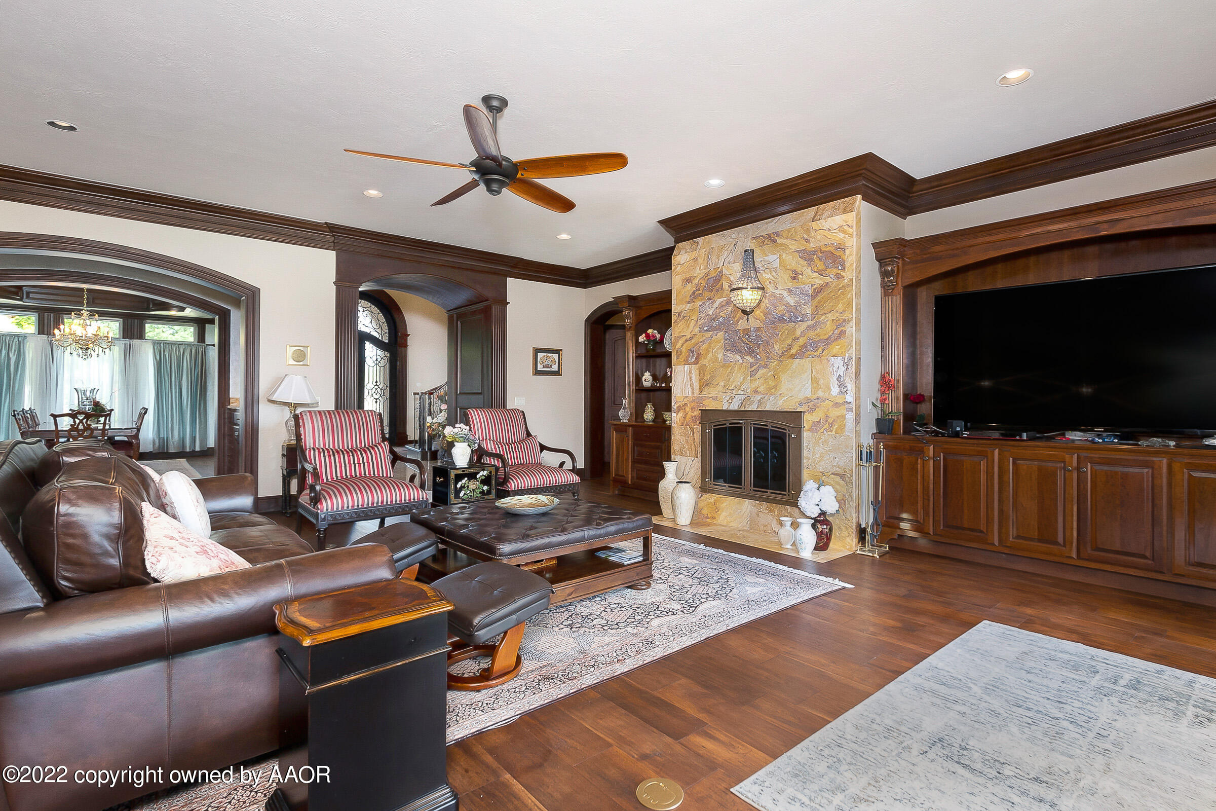 16 Merion Place Amarillo, TX 79124 - Photo 34 of 71 a living room with furniture a flat screen tv and a fireplace