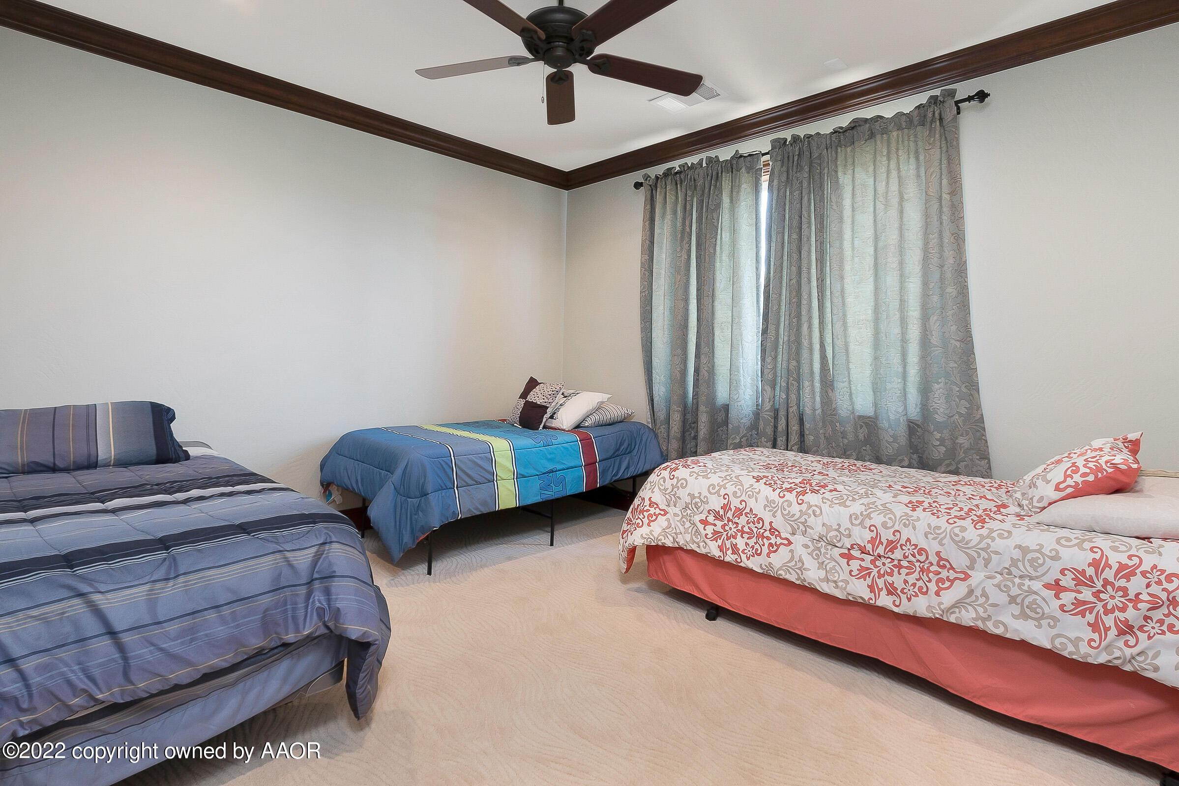 16 Merion Place Amarillo, TX 79124 - Photo 65 of 71 a bedroom with two beds and ceiling fan