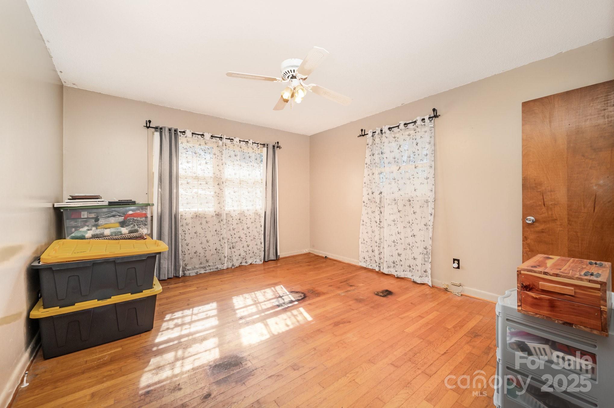 2415 Heavner Road Lincolnton, NC 28092 - Photo 11 of 21 a bedroom with a bed and a chandelier