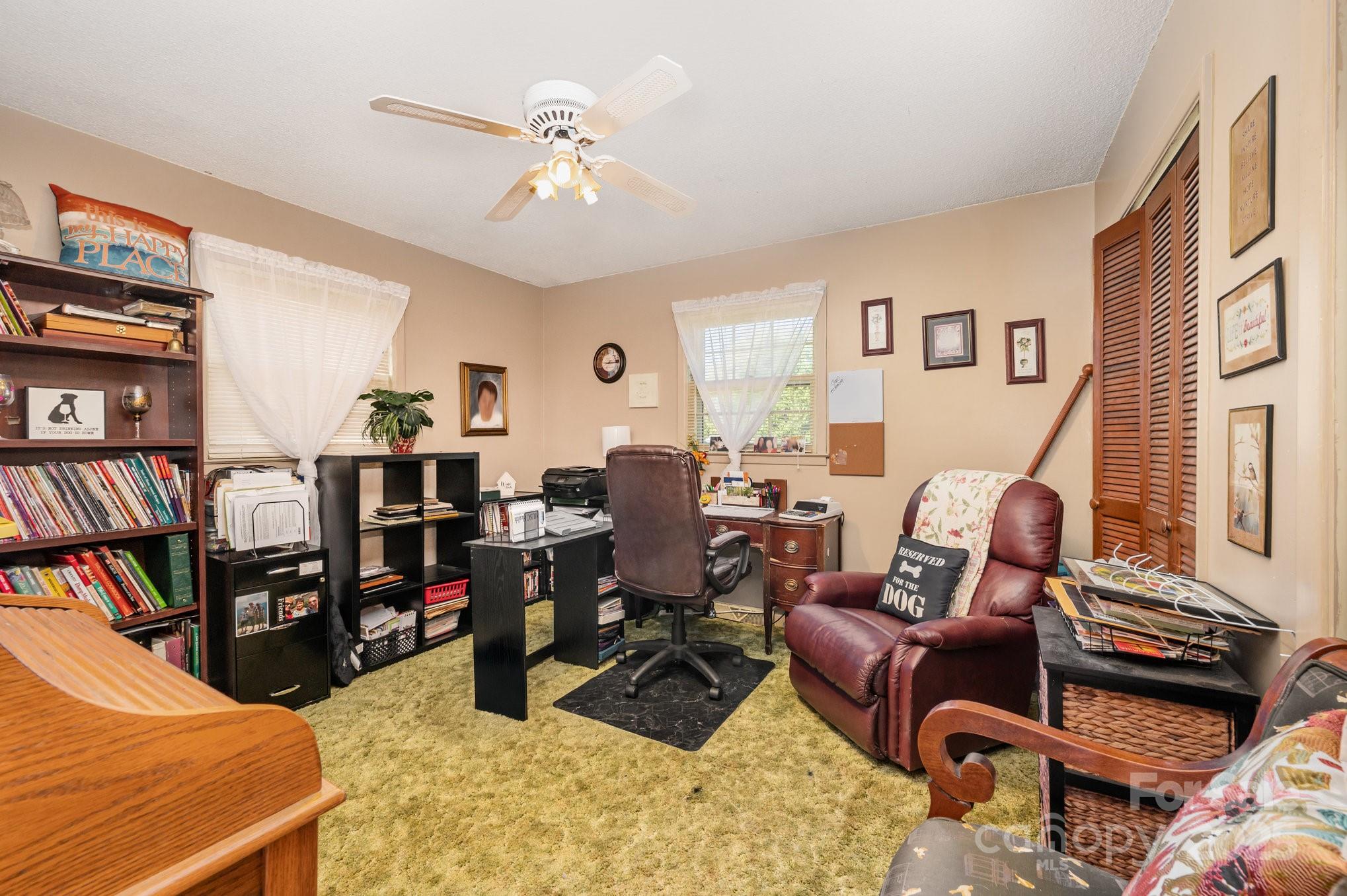 2415 Heavner Road Lincolnton, NC 28092 - Photo 13 of 21 a living room with furniture a flat screen tv and a book shelf