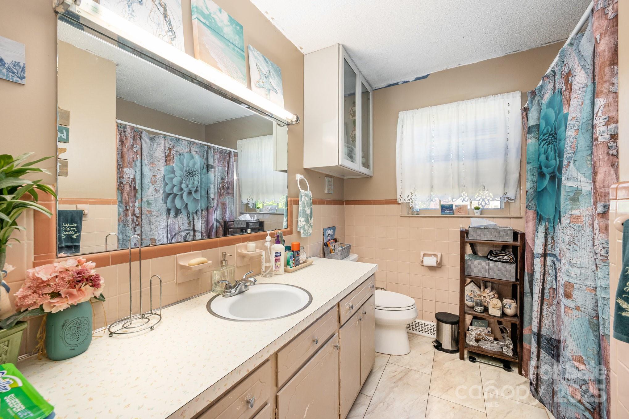 2415 Heavner Road Lincolnton, NC 28092 - Photo 14 of 21 a bathroom with a sink a toilet and a mirror