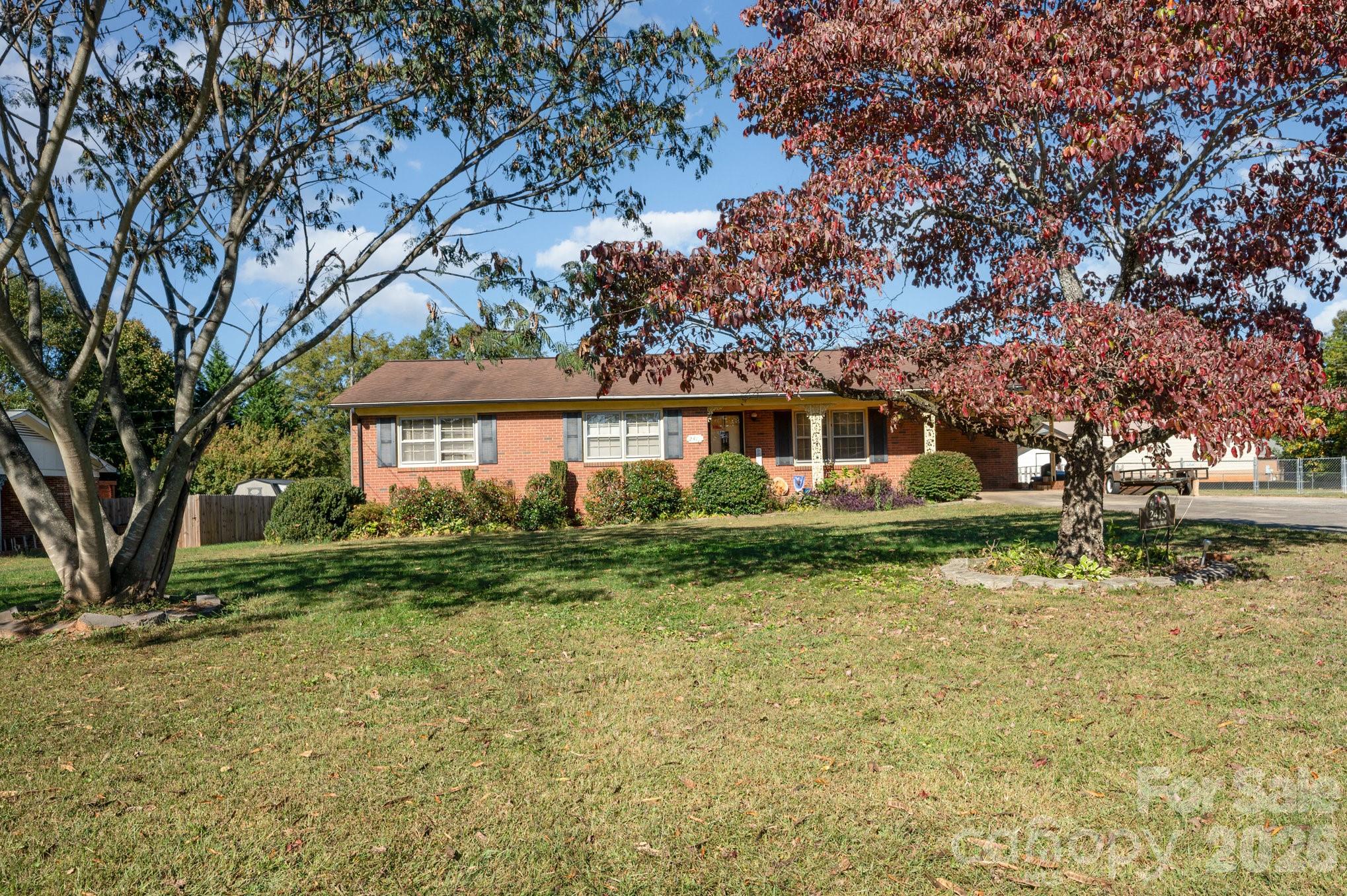 2415 Heavner Road Lincolnton, NC 28092 - Photo 19 of 21 a front view of a house with a garden