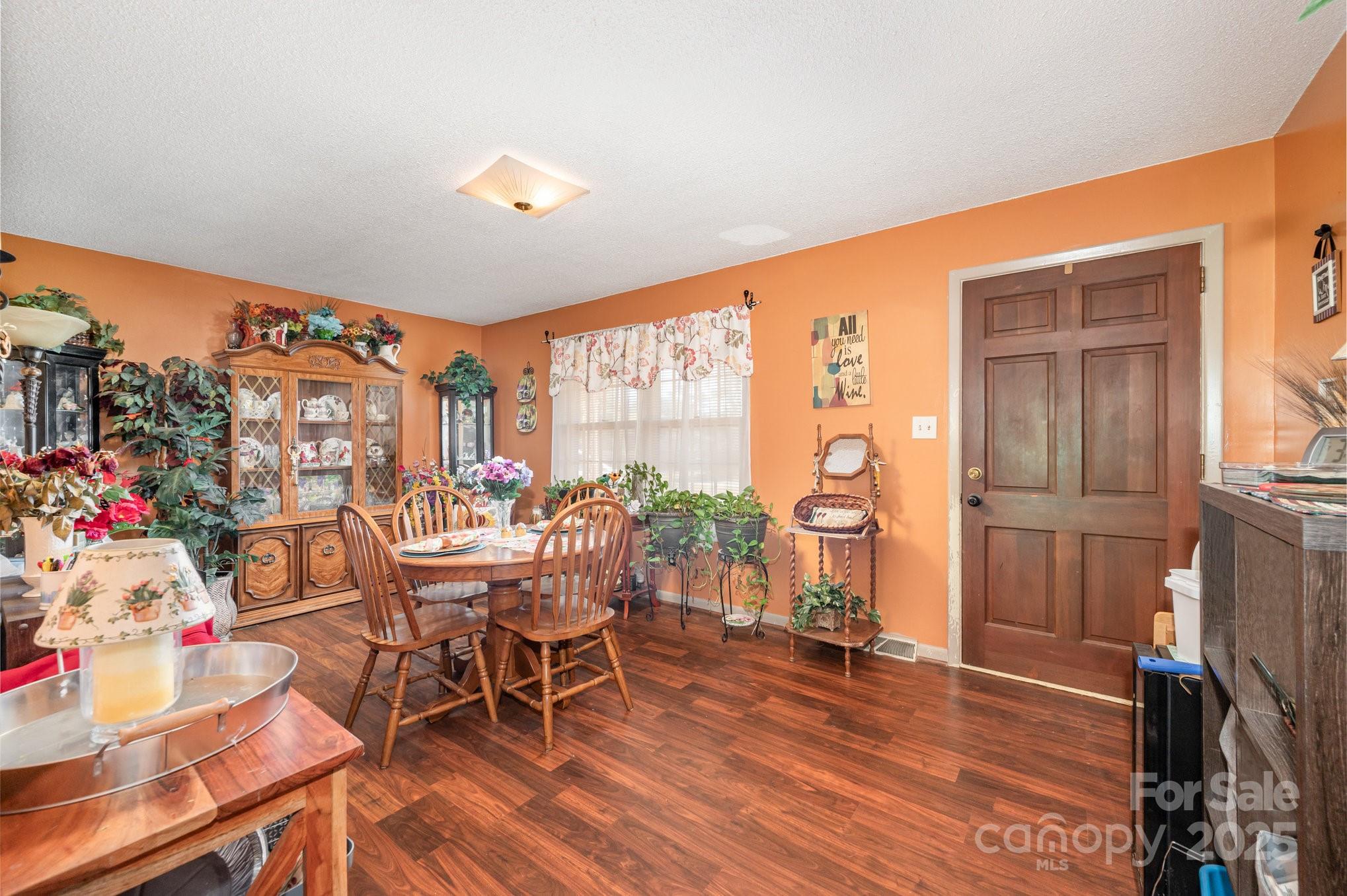 2415 Heavner Road Lincolnton, NC 28092 - Photo 2 of 21 a view of a dining room with furniture window and wooden floor