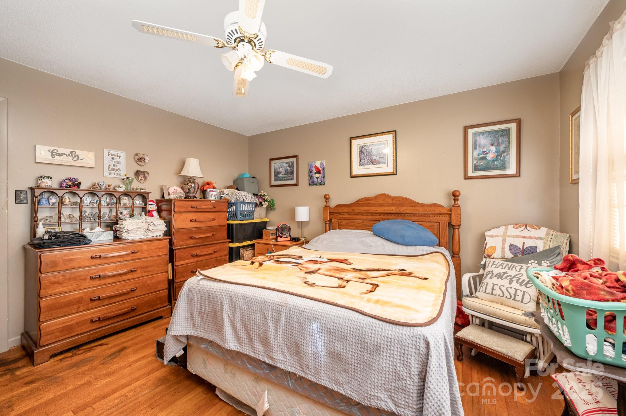 2415 Heavner Road Lincolnton, NC 28092 - Photo 9 of 21 a bedroom with a bed and a chandelier