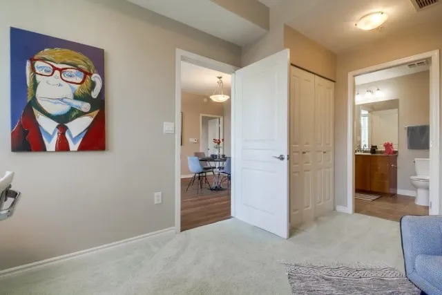 a view of a hallway with bathroom and a area