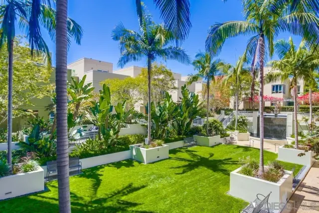 a view of a house with a yard and sitting area