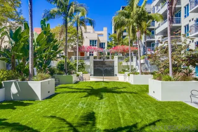 a patio with water fountain and outdoor seating