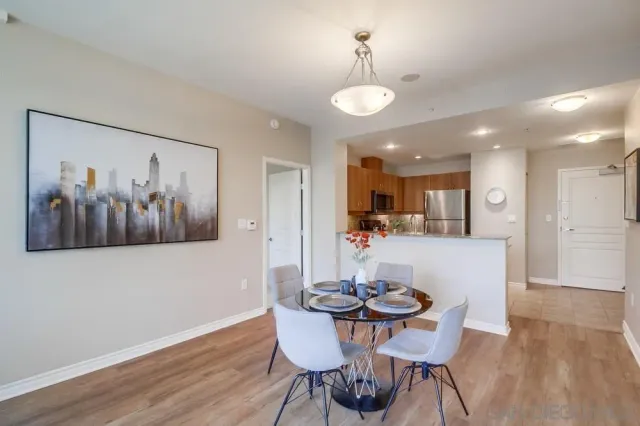 a view of a dining room with furniture and wooden floor