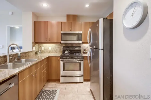 a kitchen with stainless steel appliances a stove a sink and a microwave
