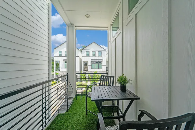 a view of balcony with a table and chairs